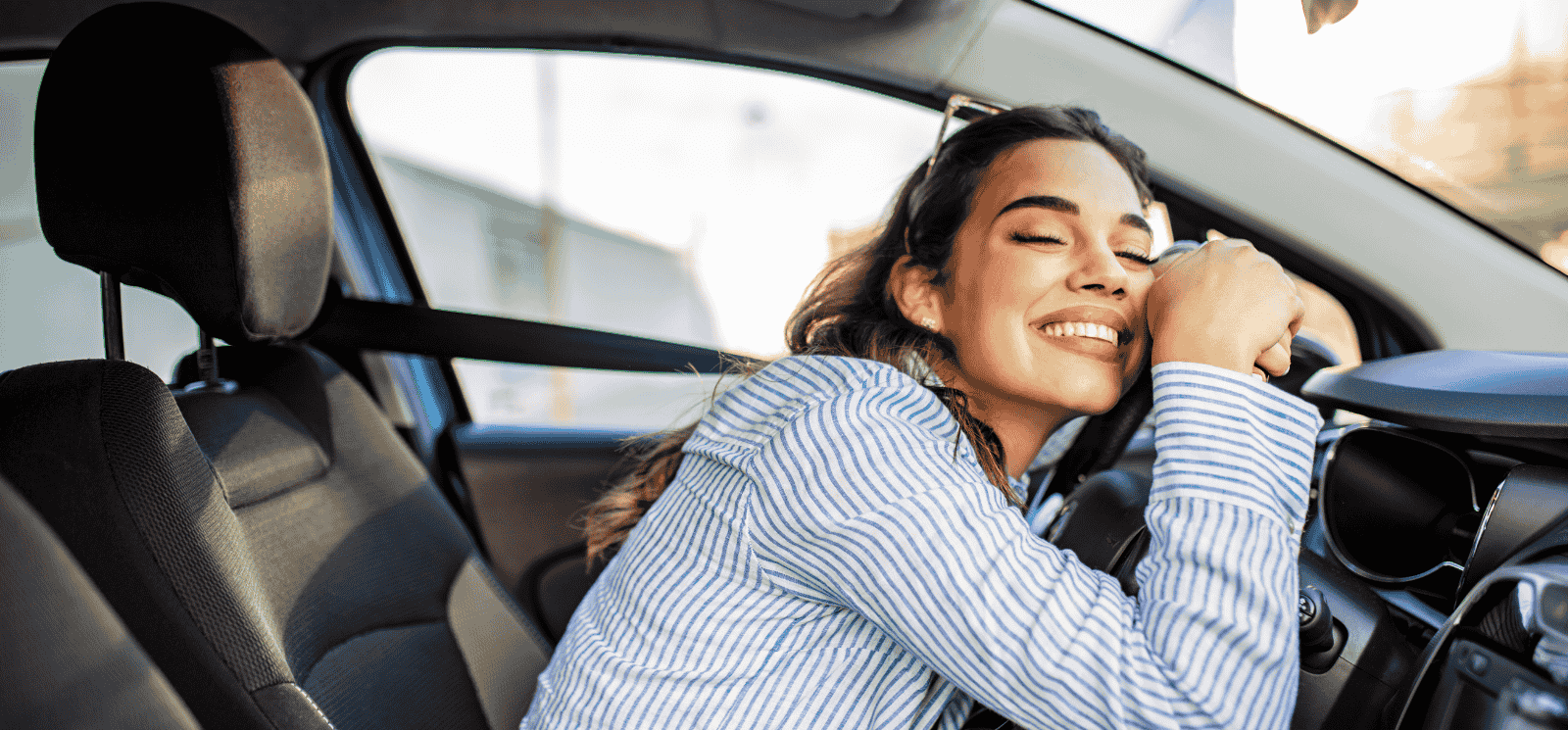 Woman hugging steering wheel